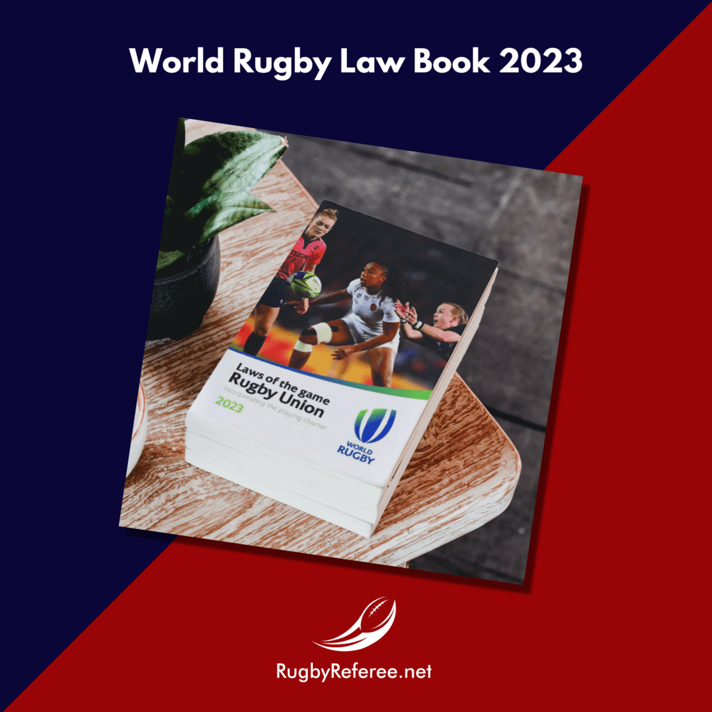 Picture of the 2023 World Rugby Law book. Image shows a Hollie Davidson referee, Kendra Cocksedge (NZ) and Sadiya Kabaya (Eng)